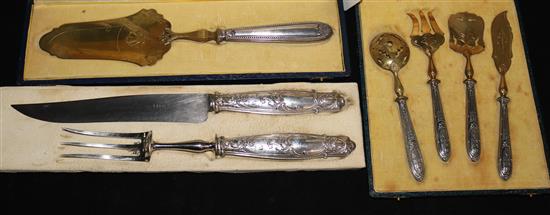 Three French silver cased sets: carving knife & fork, cake server and four piece fruit set.
